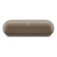 Bezprzewodowy głośnik Beats Pill w kolorze szampańskiego złota z charakterystycznym logo marki na środku metalowej maskownicy o zaokrąglonym kształcie.