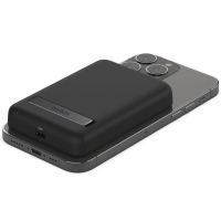 Czarny powerbank Belkin z podstawką magnetyczną przymocowany do tylnej obudowy iPhone'a, widoczny port ładowania z napisem INPUT oraz wyspa aparatów.