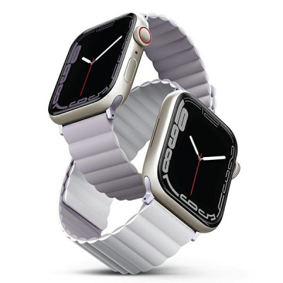Dwa zegarki Apple Watch z jasnymi kopertami i dwustronnymi paskami UNIQ Revix w kolorach liliowym oraz białym, ukazane pod kątem z widocznymi tarczami.