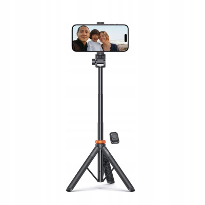 Czarny selfie stick Tech-Protect L03S z rozkładanym statywem i bezprzewodowym pilotem, podtrzymujący smartfon z wyświetlonym zdjęciem rodziny na tle morza.