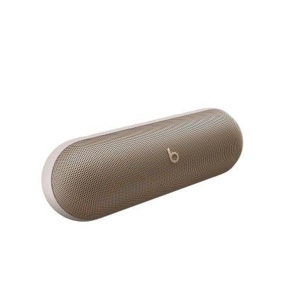 Bezprzewodowy głośnik Beats Pill w kolorze szampańskiego złota o zaokrąglonym, podłużnym kształcie z widocznym logo marki na środku metalowej maskownicy.